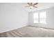 Bedroom with plush neutral carpet, neutral walls, and two windows that provide natural light at 324 Longleaf Glen Court, Zebulon, NC 27597