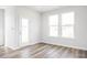 Bright space featuring hard wood floors, white walls, and large windows that provide natural light at 324 Longleaf Glen Court, Zebulon, NC 27597