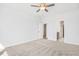 Bright main bedroom with neutral carpet, ceiling fan, and two closets with passage to the bathroom at 324 Longleaf Glen Court, Zebulon, NC 27597