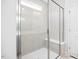 Modern bathroom featuring a glass shower with gray tiling, a built-in bench, and a bright, clean design at 324 Longleaf Glen Court, Zebulon, NC 27597