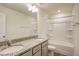 Bathroom with double sinks, granite counters, and shower-tub combo at 3505 Triad Ct, Raleigh, NC 27604