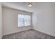 Bedroom with gray carpet features a window and door to hallway at 3505 Triad Ct, Raleigh, NC 27604