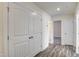 Hallway with wood-look floors leading to various rooms at 3505 Triad Ct, Raleigh, NC 27604