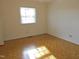 Sunlit bedroom showcasing wood floors and a window, perfect for relaxation at 3738 Jamestown Cir, Raleigh, NC 27609