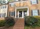 Charming brick townhome with a welcoming entrance and manicured landscaping at 3738 Jamestown Cir, Raleigh, NC 27609