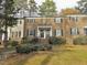 Brick townhouse with black shutters and landscaping at 3738 Jamestown Cir, Raleigh, NC 27609