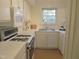 Cozy kitchen with white cabinets and appliances at 3738 Jamestown Cir, Raleigh, NC 27609