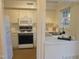 Bright kitchen with white appliances and ample cabinet space at 3738 Jamestown Cir, Raleigh, NC 27609