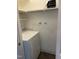 Practical laundry room setup with washer, dryer, and added shelving at 3738 Jamestown Cir, Raleigh, NC 27609