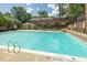 Refreshing community pool surrounded by lounge chairs and greenery at 3738 Jamestown Cir, Raleigh, NC 27609