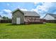 Spacious backyard with a well-maintained lawn and partial deck view at 402 Hearthstone Dr, Nashville, NC 27856