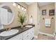 Well-lit bathroom featuring double sinks and decorative elements at 402 Hearthstone Dr, Nashville, NC 27856