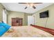 Bright bedroom with a ceiling fan, dresser, and a wall-mounted television at 402 Hearthstone Dr, Nashville, NC 27856