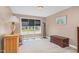 Neutral bedroom with large window and wood furnishings at 402 Hearthstone Dr, Nashville, NC 27856