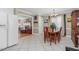Cozy dining room adjacent to the living room featuring tile flooring and neutral decor at 402 Hearthstone Dr, Nashville, NC 27856