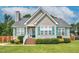 Charming single story home featuring light tan siding, a chimney, and a well maintained front yard at 402 Hearthstone Dr, Nashville, NC 27856