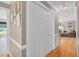 Hallway featuring wood flooring, coat closet, and entry to living room at 402 Hearthstone Dr, Nashville, NC 27856