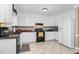 Bright kitchen with white cabinets, tiled floors, and a full-sized refrigerator at 402 Hearthstone Dr, Nashville, NC 27856