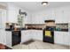 Efficient kitchen featuring white cabinetry, black appliances, and ample countertop space for meal preparation at 402 Hearthstone Dr, Nashville, NC 27856