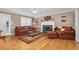 Spacious living room featuring a fireplace, hardwood floors, and a ceiling fan for added comfort at 402 Hearthstone Dr, Nashville, NC 27856