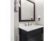 Bathroom vanity featuring dark wood cabinets, marble countertop and silver faucet at 4211 Norman Ridge Ln, Raleigh, NC 27613