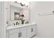 Bathroom with a double vanity, marble countertops, and modern fixtures at 4211 Norman Ridge Ln, Raleigh, NC 27613