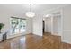 Dining room with hardwood floors, crown molding, and a large window at 4211 Norman Ridge Ln, Raleigh, NC 27613