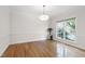 Bright dining room with hardwood floors, large window view and elegant chandelier at 4211 Norman Ridge Ln, Raleigh, NC 27613