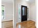 Foyer with a decorative glass front door and hardwood floors at 4211 Norman Ridge Ln, Raleigh, NC 27613