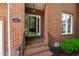 Close up of front door with brick steps and black handrails at 4211 Norman Ridge Ln, Raleigh, NC 27613
