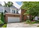 Charming brick home featuring an attached two-car garage and professionally landscaped front yard at 4211 Norman Ridge Ln, Raleigh, NC 27613