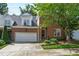 Charming brick home featuring an attached two-car garage and professionally landscaped front yard at 4211 Norman Ridge Ln, Raleigh, NC 27613