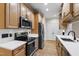 Kitchen with light wood cabinets, quartz countertops and stainless steel appliances at 4211 Norman Ridge Ln, Raleigh, NC 27613