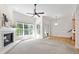 Spacious living room with cozy fireplace and windows, enhanced by hardwood and carpet flooring at 4211 Norman Ridge Ln, Raleigh, NC 27613
