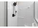 Contemporary shower boasts modern fixtures, white tile surround, and a sleek design at 4211 Norman Ridge Ln, Raleigh, NC 27613