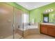 An ensuite bathroom provides a corner tub, shower, and vanity at 4613 Moores Creek Rd, Durham, NC 27705