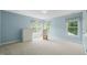 Light-filled bedroom offers serene blue walls and large windows with backyard views at 4613 Moores Creek Rd, Durham, NC 27705