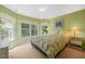 Bright bedroom with natural light, complemented by a floral comforter and bedside tables at 4613 Moores Creek Rd, Durham, NC 27705