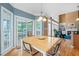 This breakfast nook features hardwood floors, large windows, and access to the screened in porch and living room at 4613 Moores Creek Rd, Durham, NC 27705