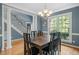 Formal dining room with a modern chandelier, large window, and classic trim, perfect for entertaining guests at 4613 Moores Creek Rd, Durham, NC 27705
