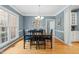 Elegant dining room featuring a large window, chandelier, and hardwood floors, ideal for Gathering gatherings at 4613 Moores Creek Rd, Durham, NC 27705