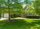 Beautiful brick home with lush green lawn and mature trees, creating a picturesque and inviting curb appeal at 4613 Moores Creek Rd, Durham, NC 27705