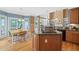 Open kitchen with granite counters, hardwood floors, stainless appliances, an island, and a breakfast nook at 4613 Moores Creek Rd, Durham, NC 27705