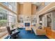 Bright living room boasts soaring ceilings, a fireplace with built-ins, and large windows that flood the space with natural light at 4613 Moores Creek Rd, Durham, NC 27705