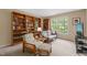 Cozy room with built-in bookshelves, comfortable seating, and ample natural light at 4613 Moores Creek Rd, Durham, NC 27705