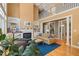 Open-concept living room with fireplace and built-ins, offering comfortable seating and a view of the second-floor balcony at 4613 Moores Creek Rd, Durham, NC 27705