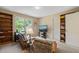 Comfortable living room featuring built-in bookcases and views of the outdoors at 4613 Moores Creek Rd, Durham, NC 27705
