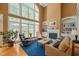 Bright living room boasts soaring ceilings, a fireplace with built-ins, and large windows that flood the space with natural light at 4613 Moores Creek Rd, Durham, NC 27705