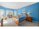 This main bedroom features lots of natural light and calm paint at 4613 Moores Creek Rd, Durham, NC 27705