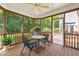 The screened porch offers a ceiling fan and an area to enjoy the outdoors at 4613 Moores Creek Rd, Durham, NC 27705